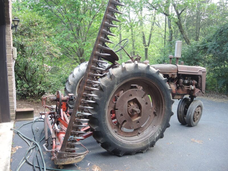 1950 Farmall C with 7' cycle bar mower, 2-bottom plow, and disc